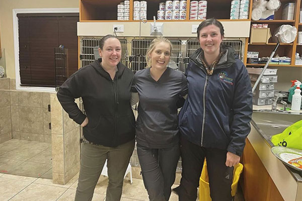 three female qrph staff members standing together and smiling